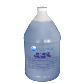 Blue plastic jug of dry-quick rinse additive with a white cap, against a black background. The label features blue text and a logo with a globe design.